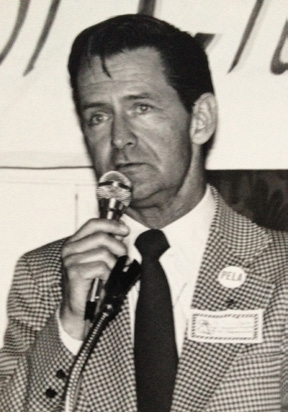 James Baxter speaking at a podium